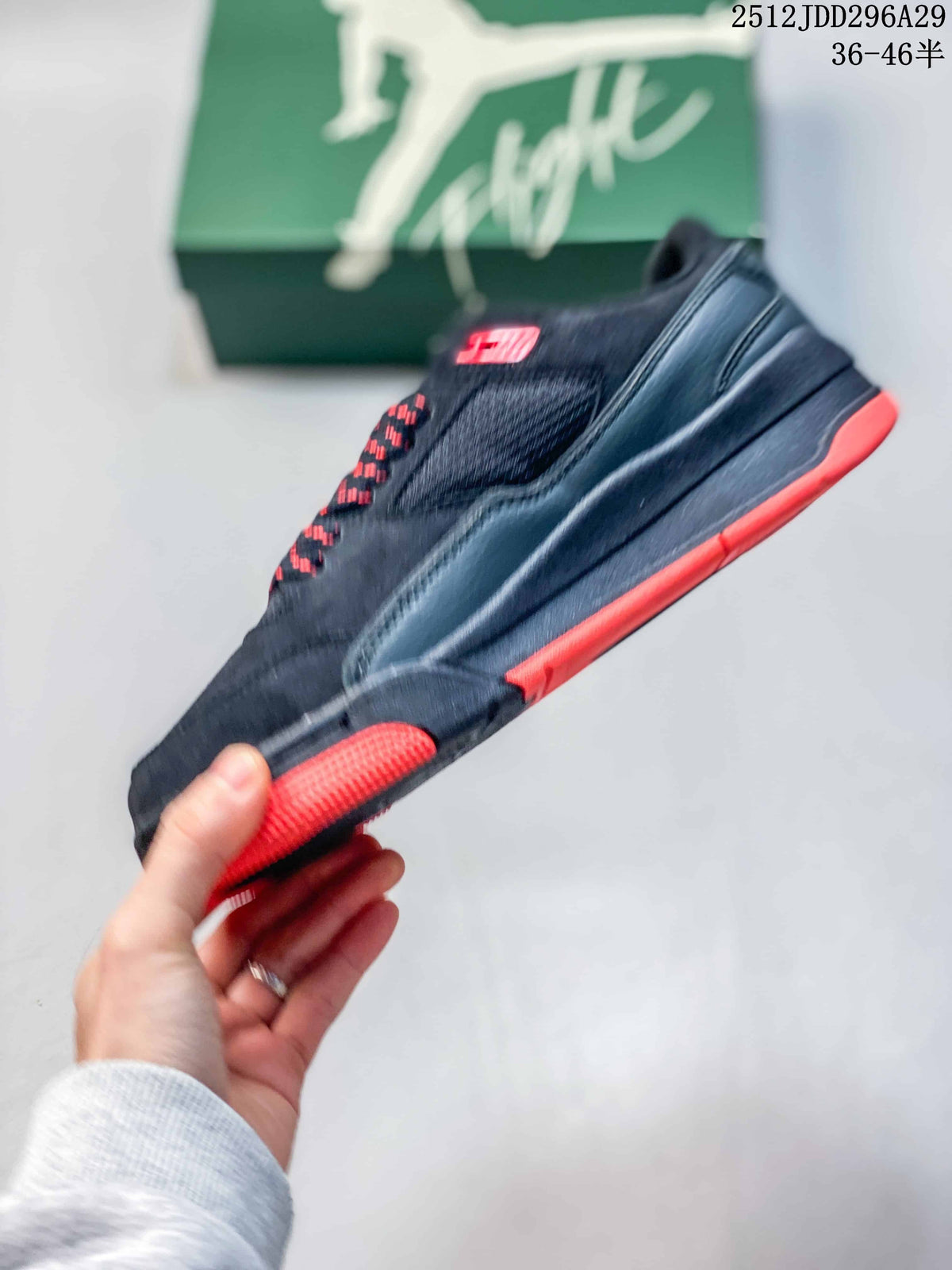 Side profile showing the black layered upper, mesh panel and red outsole accents.