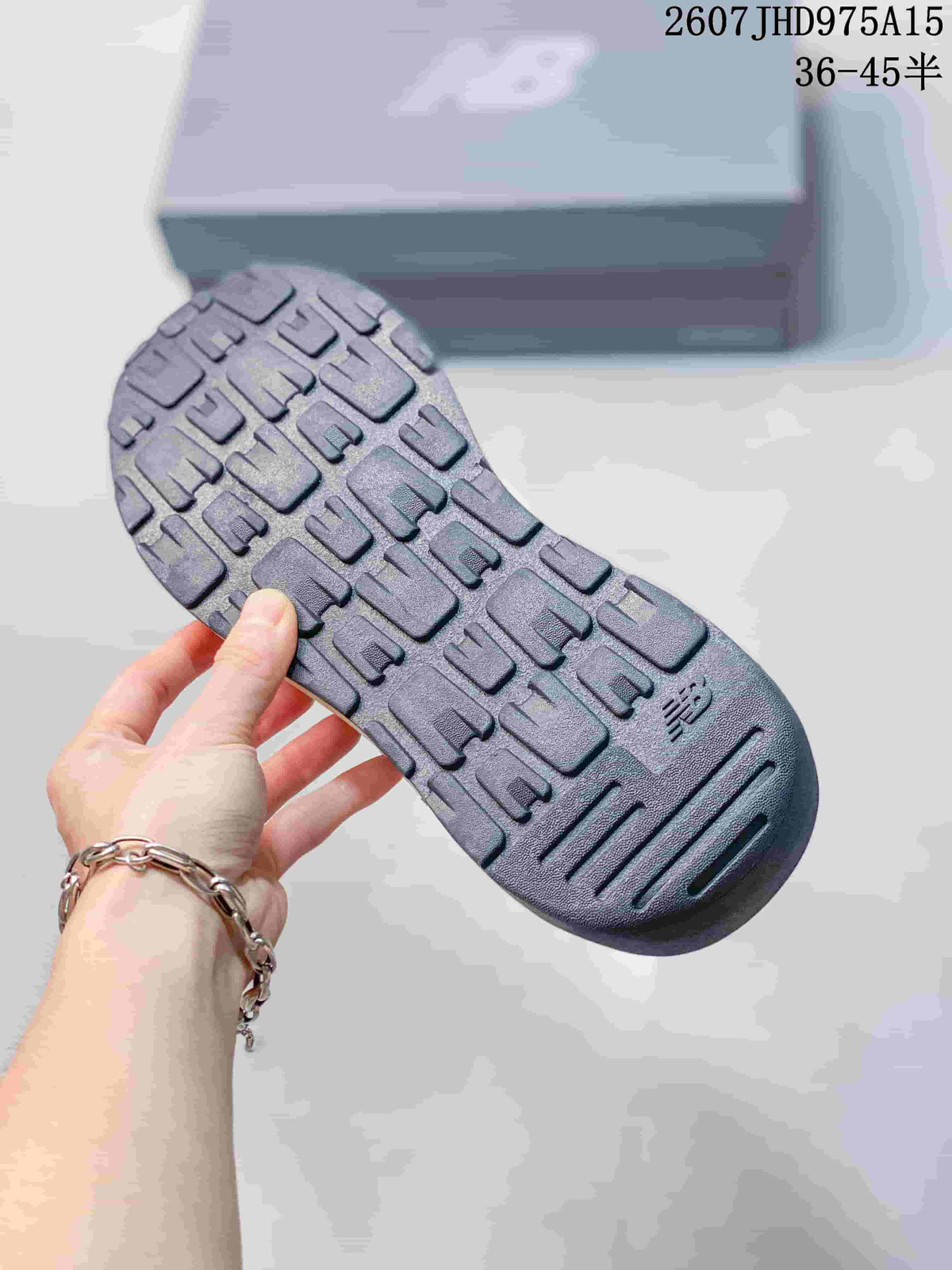 Close view of the segmented textured outsole on a New Balance 5740 sneaker.