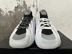 Front view of white and black sneakers with gray toe accents and contrasting lace options