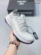 Close-up side view of a white Arc'teryx Sylan shoe showing the lace-up upper, tongue branding, and lugged outsole.