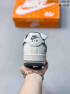 Rear view of a white sneaker showing the Nike Air heel tab, black collar lining, and dark outsole edge.