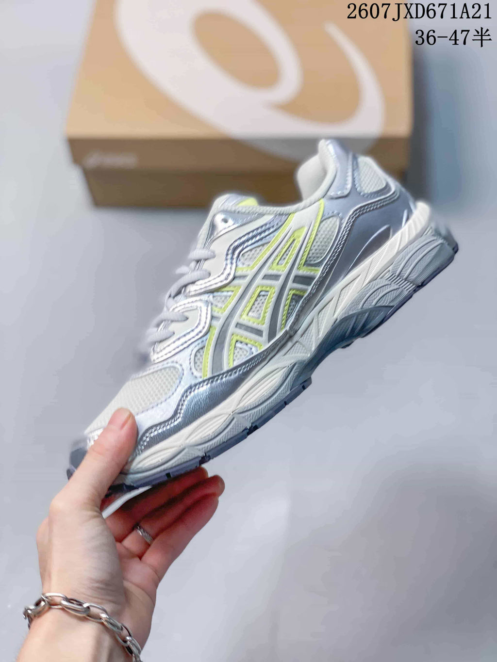 Side view showing the layered upper, mesh panels, silver overlays, and lime accents.