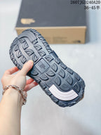 Close view of the sandal outsole showing a deep, textured tread pattern and a central branded section.