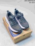 Pair of dark ASICS GT-2000 13 running sneakers displayed on an ASICS shoebox.