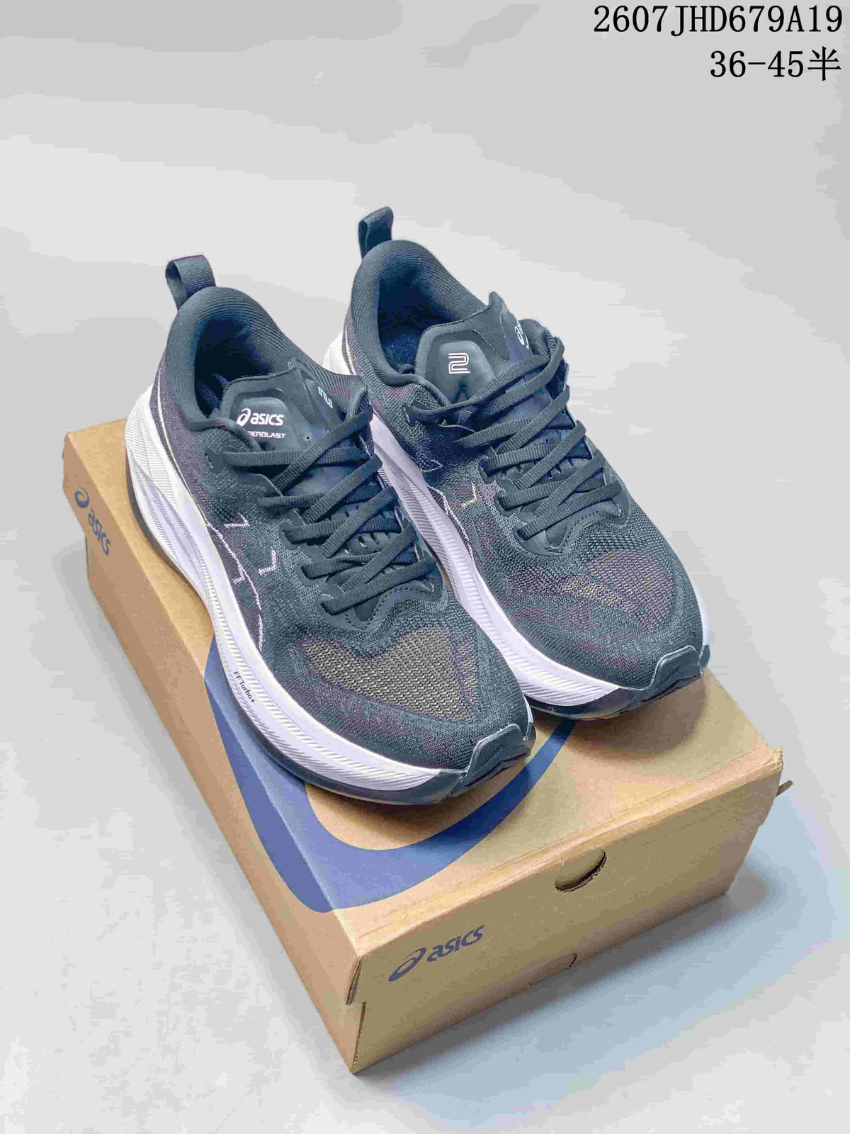 Pair of dark ASICS GT-2000 13 running sneakers displayed on an ASICS shoebox.
