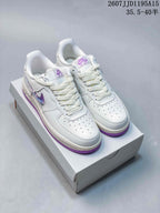 Pair of white and purple Nike Air Force 1 low-top sneakers displayed on a white shoe box.