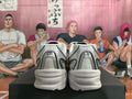 Rear view of silver-tone New Balance 530 sneakers with light-colored layered soles.