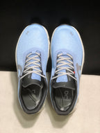 Top view showing the light blue uppers, patterned laces, black tongues, and branded insoles.