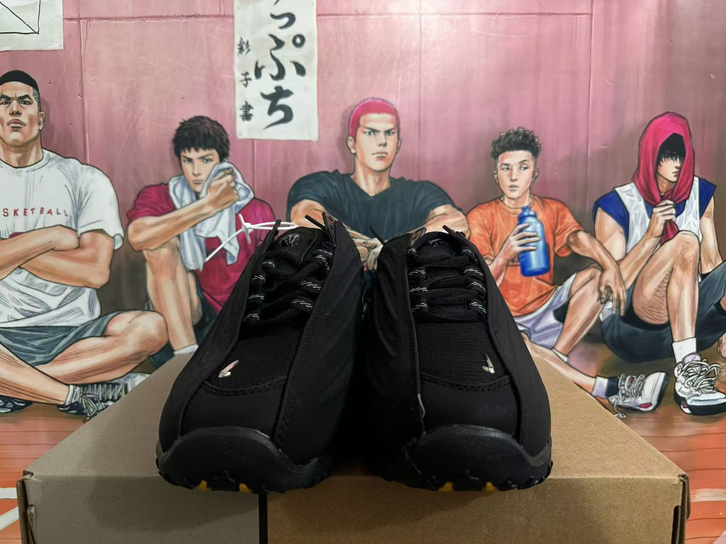Front view of black Nike sneakers showing the laces and toe area.