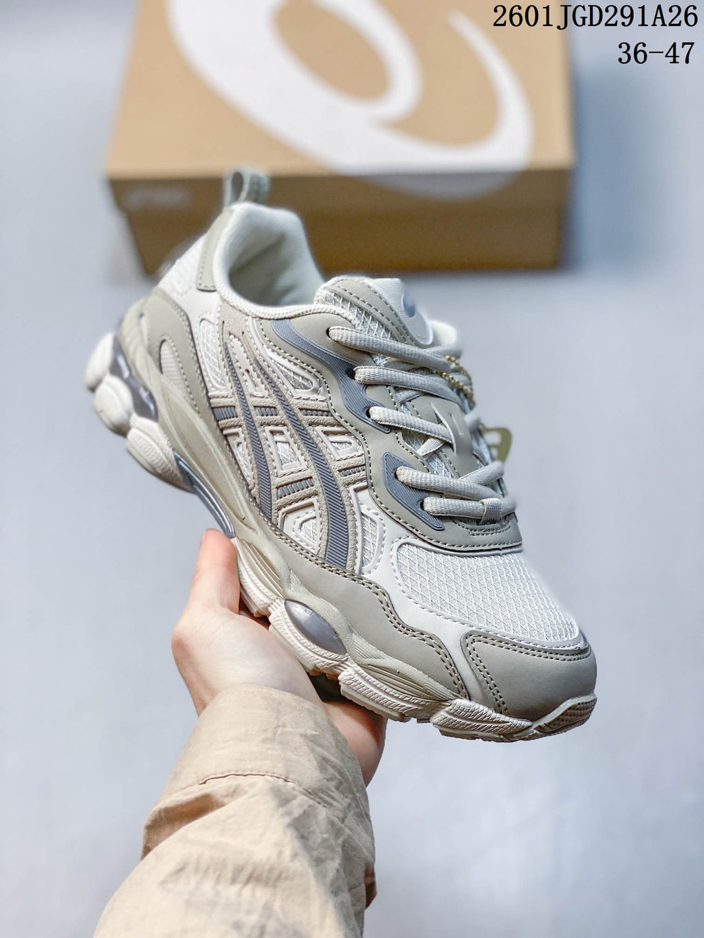 Three-quarter side view highlighting the gray and white layered upper and textured outsole.