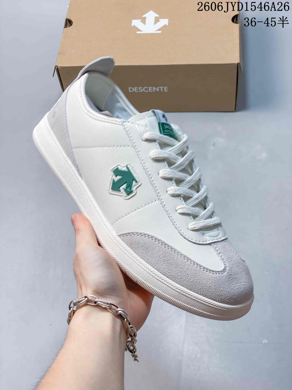 Close-up of a white and pale gray sneaker with green side emblem
