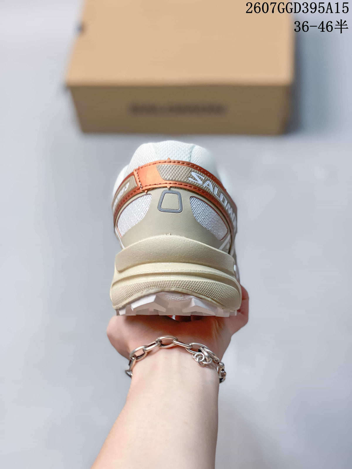 Rear view showing the padded heel, layered heel structure and lugged outsole of the Salomon trail shoes.