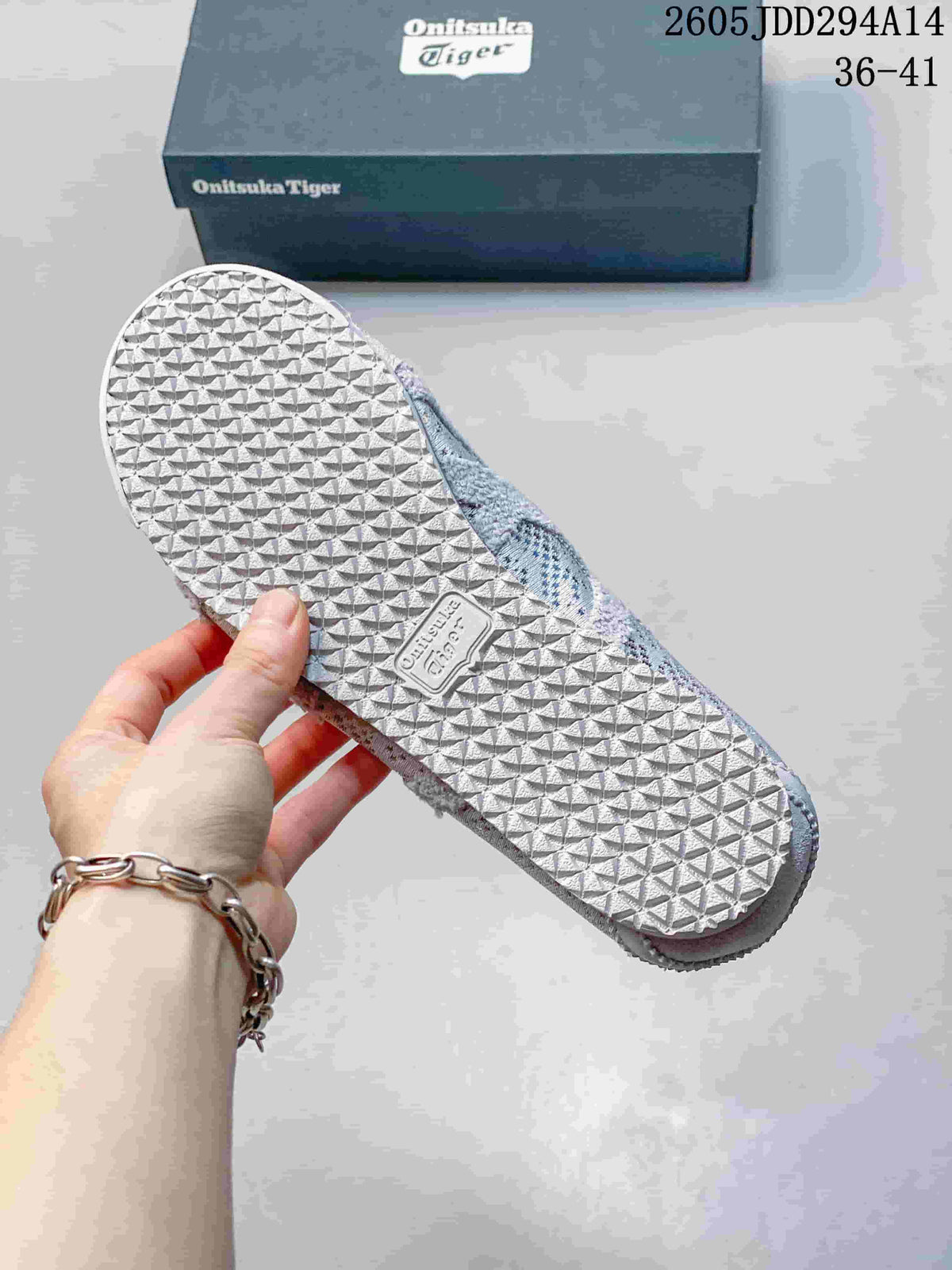 Close view of the textured rubber outsole showing its repeating geometric tread pattern, with an Onitsuka Tiger shoebox in the background.