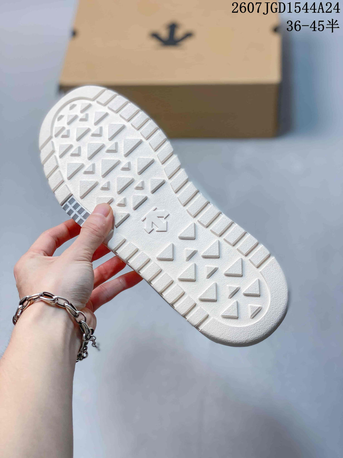 Close view of the white sneaker outsole showing a geometric traction pattern.