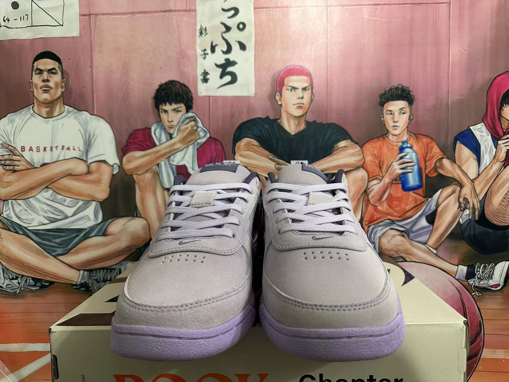 Front view of gray low-top sneakers with matching laces and purple outsoles