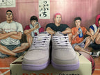 Front view of gray low-top sneakers with matching laces and purple outsoles