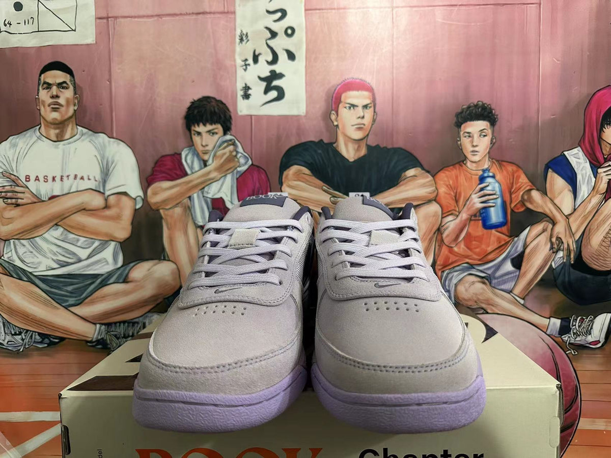 Front view of gray low-top sneakers with matching laces and purple outsoles