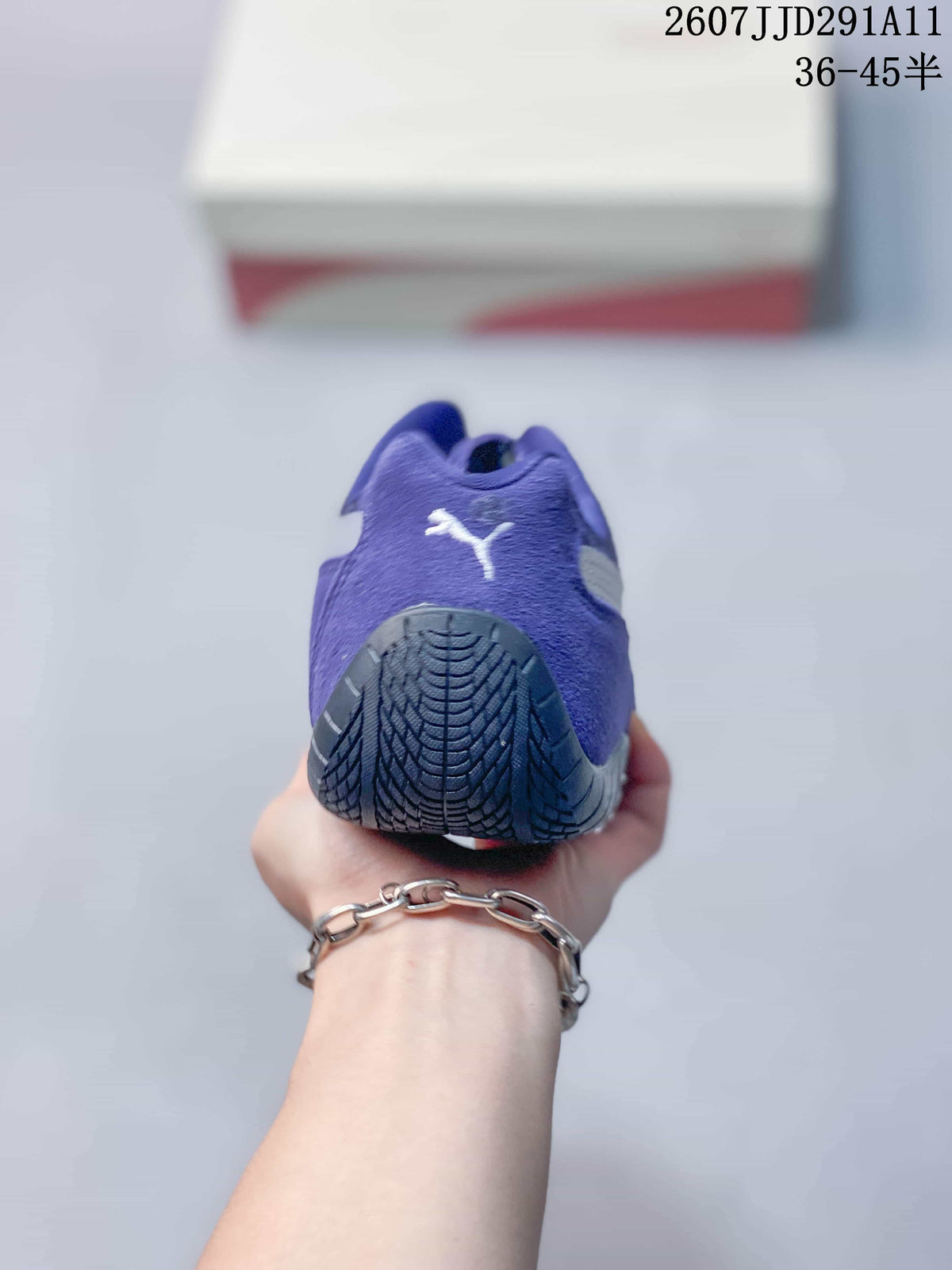 Rear view of the purple sneaker showing the heel Puma logo and dark outsole.