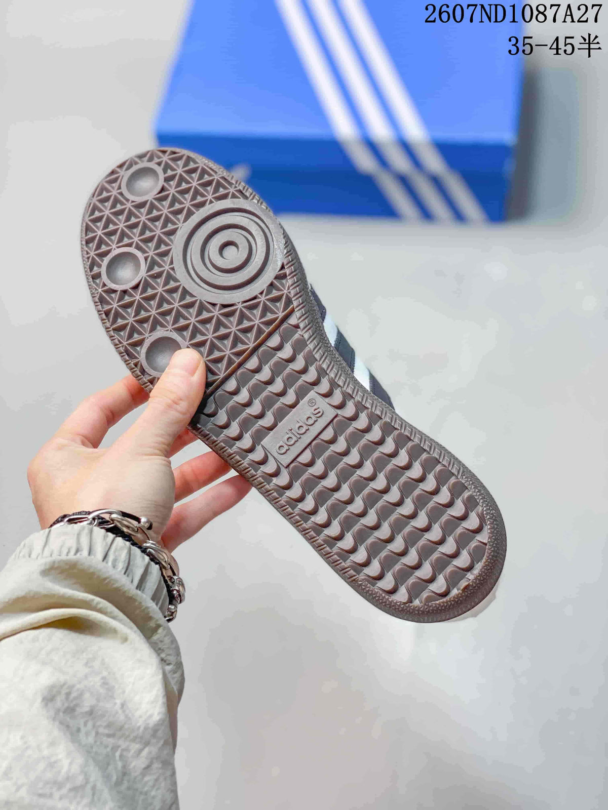 Close-up of the textured gum-colored outsole with geometric tread and adidas branding.