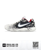 Side view of white low-top Nike basketball sneakers with black splatter-style graphics and red lining.