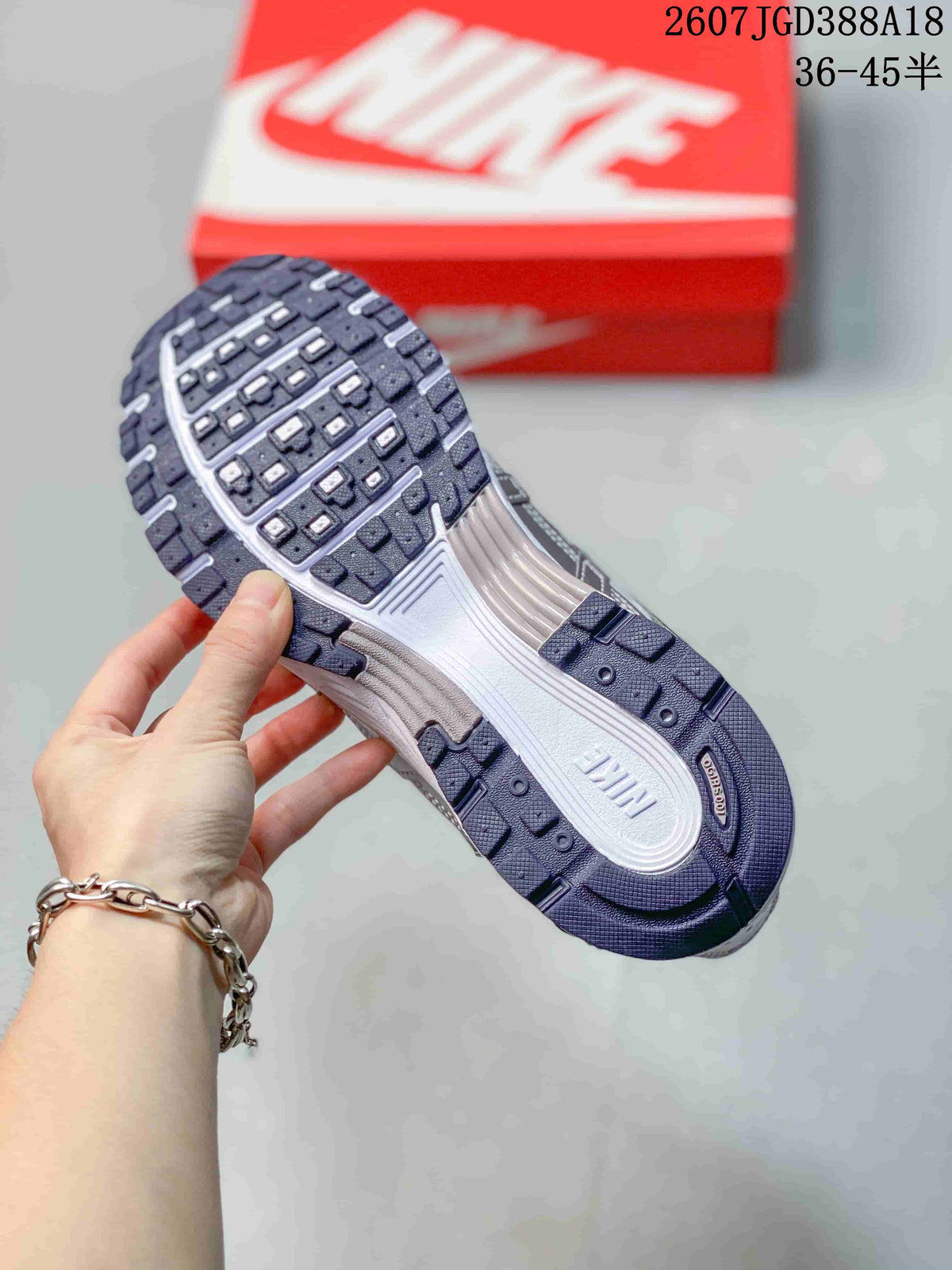 Close view of the Nike P-6000 outsole showing segmented dark tread and a light-colored midsole.