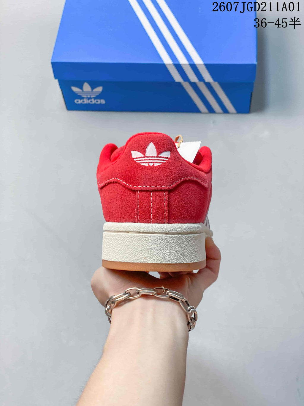 Rear view of the red sneaker with an off-white midsole