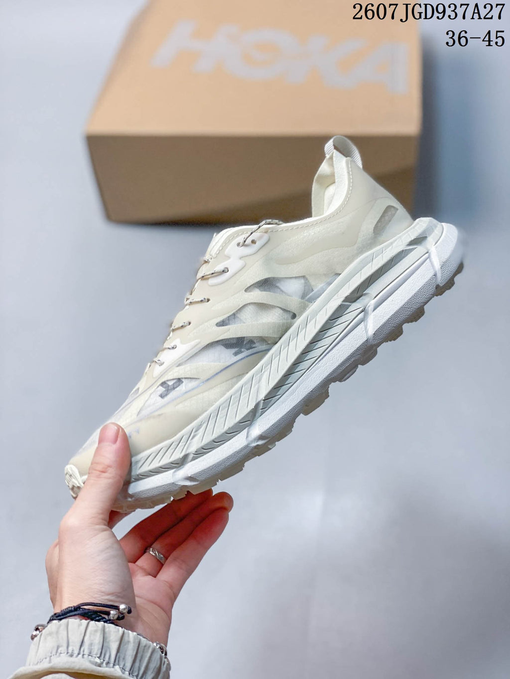 Side view highlighting the layered upper panels, translucent-looking side sections, and thick white sole.