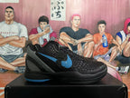Side view of a black basketball shoe with a blue Swoosh and gray heel panel