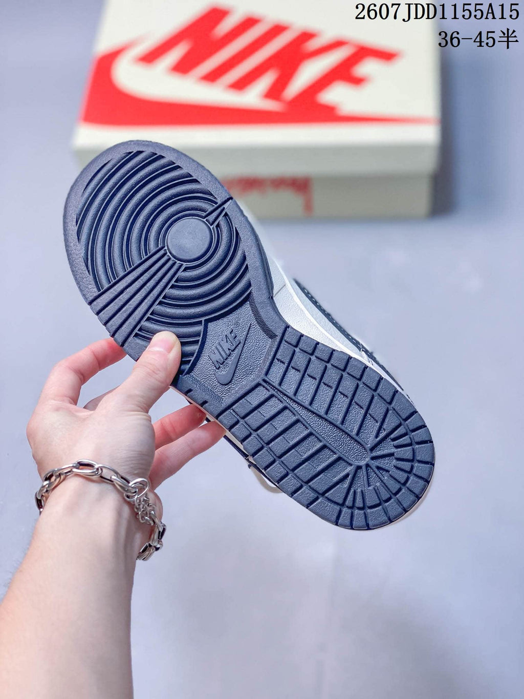 Close-up of the dark navy Nike outsole with circular traction at the forefoot and patterned tread through the heel.