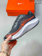 Side profile highlighting the orange graphics and sculpted white midsole