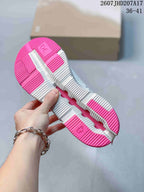 Underside view showing the white and bright pink segmented outsole with textured tread and cutouts.