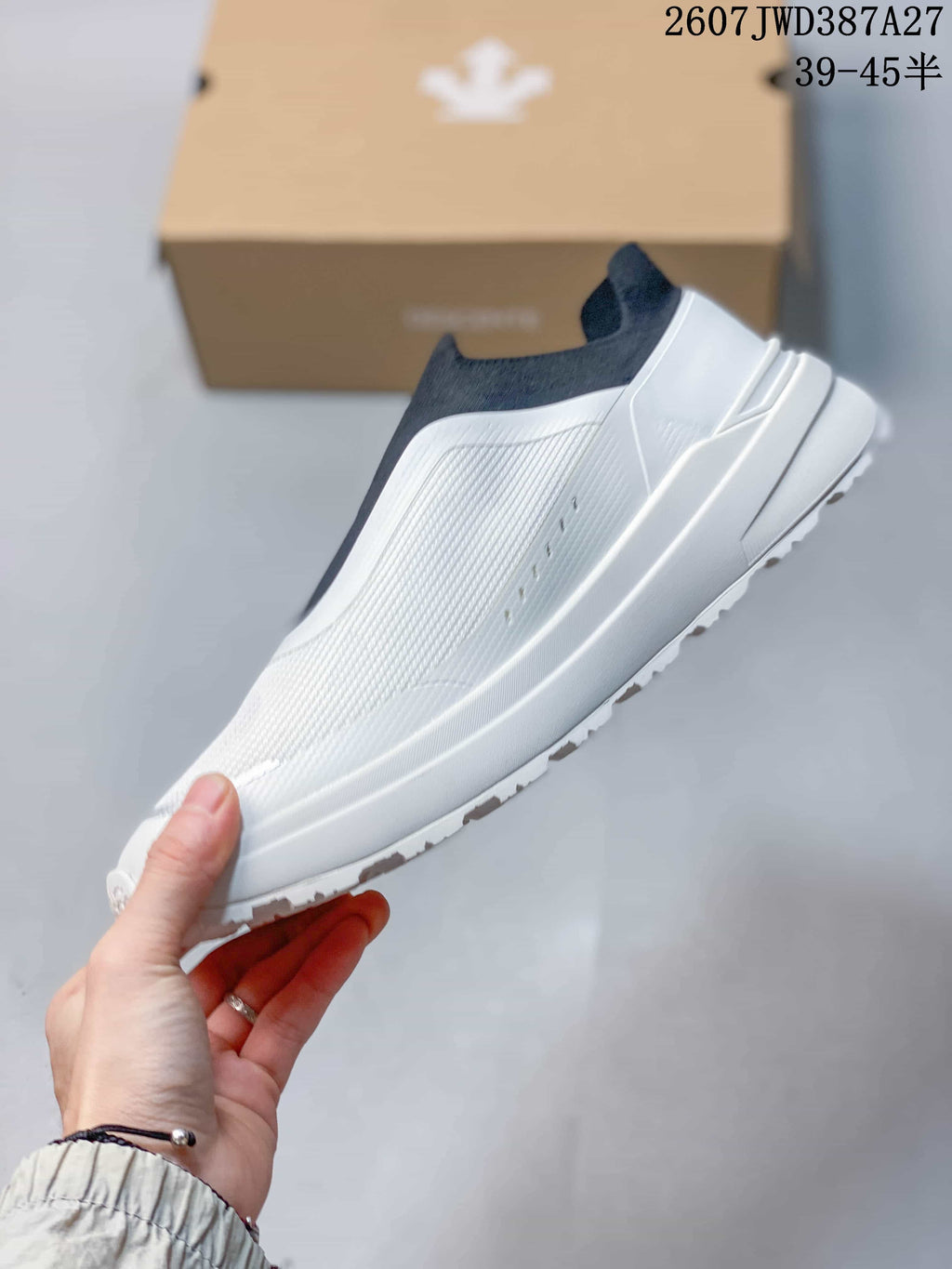 Side view showing the white low-cut slip-on profile and textured upper.