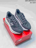 Pair of dark gray and white New Balance RC Elite running shoes displayed on a red shoebox.