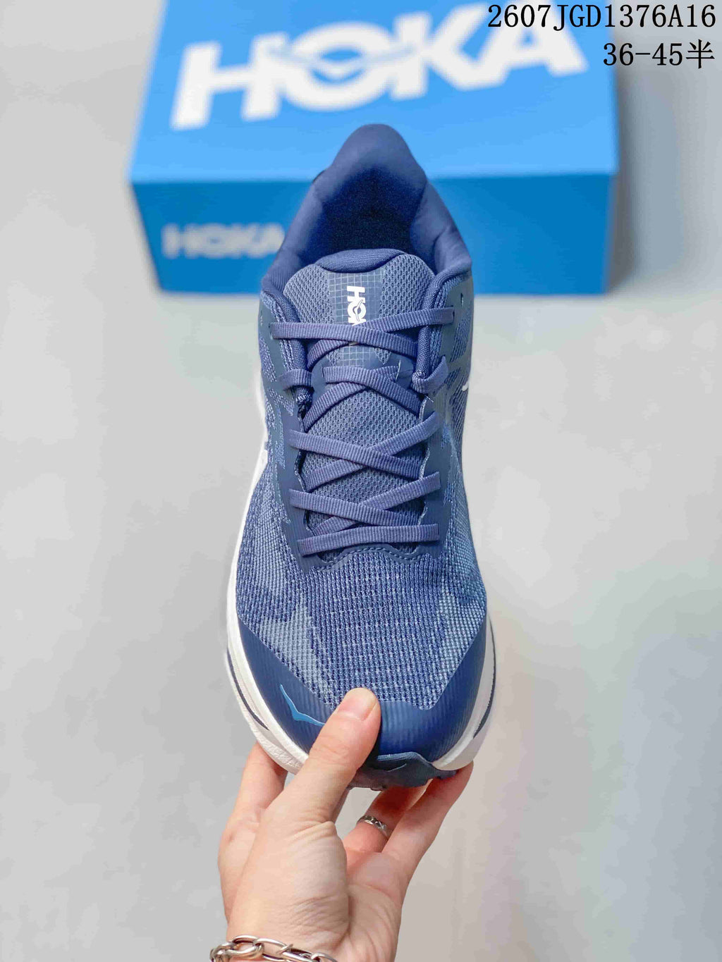 Front view of the blue lace-up running shoe with a textured upper and padded tongue.