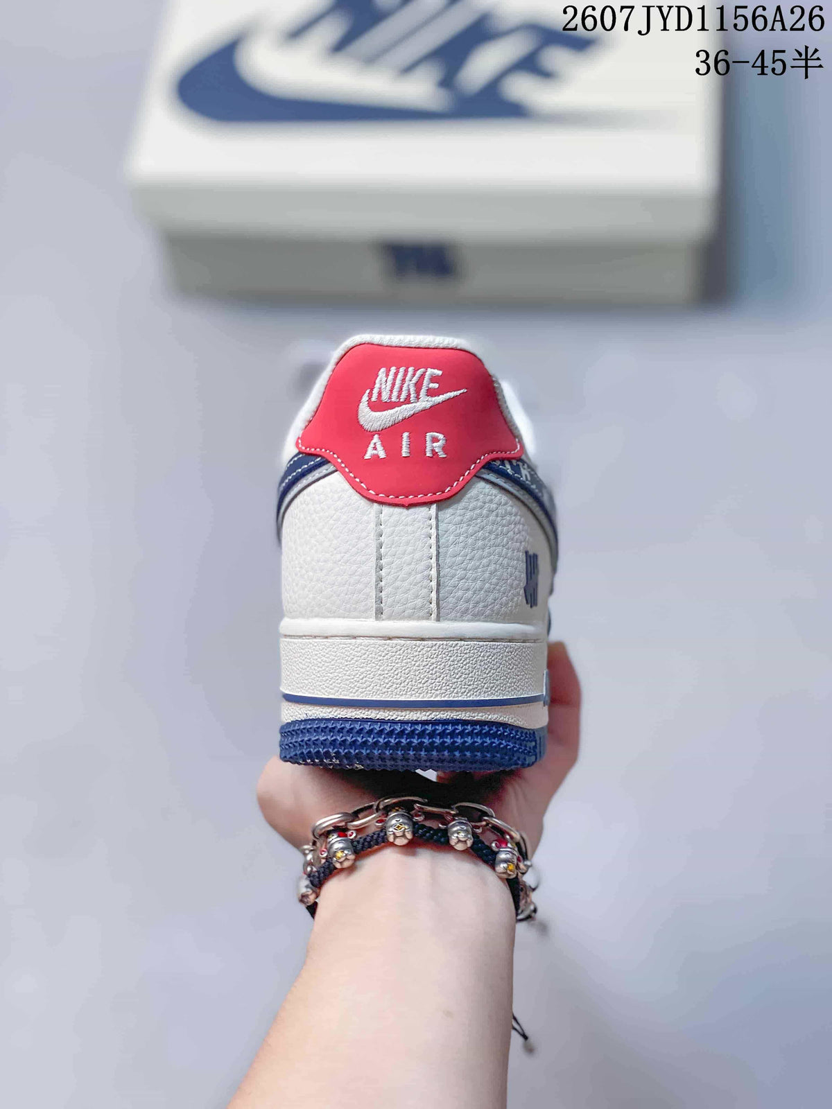 Rear view showing the white heel, red heel tab and blue outsole of the sneaker.