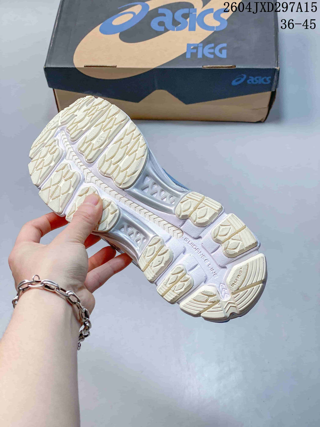 Underside view showing the sneakers' patterned outsole and tread