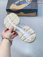 Underside view showing the sneakers' patterned outsole and tread