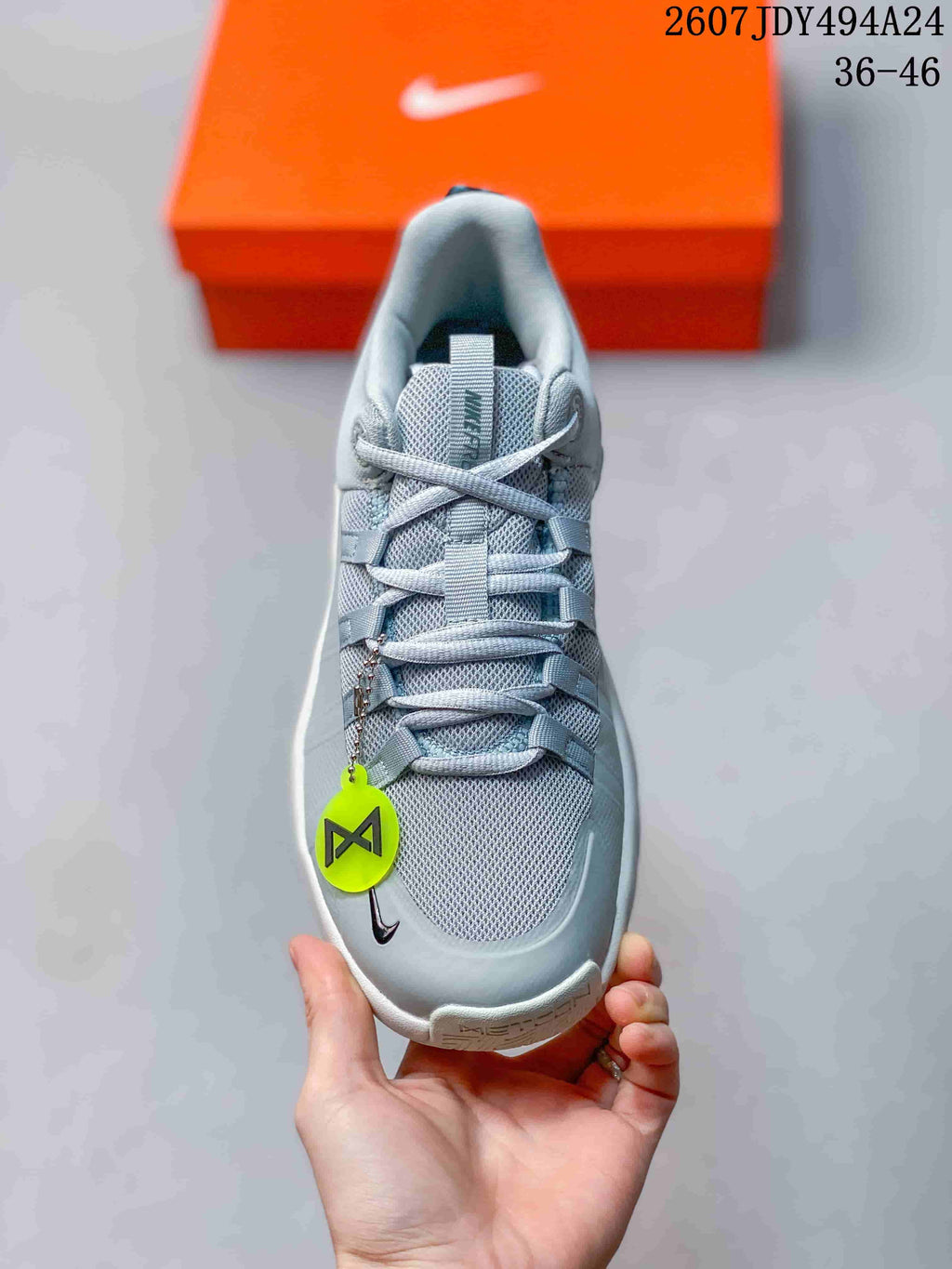 Top view showing the mesh-style toe box, laces, tongue, and neon green hanging tag.