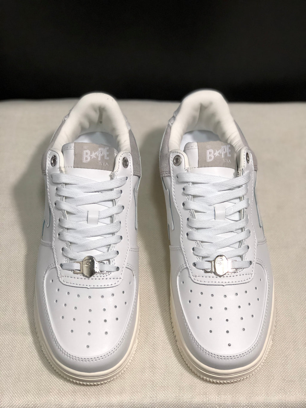 Front view highlighting the perforated white toe boxes, lace closure, and metallic lace accessories.