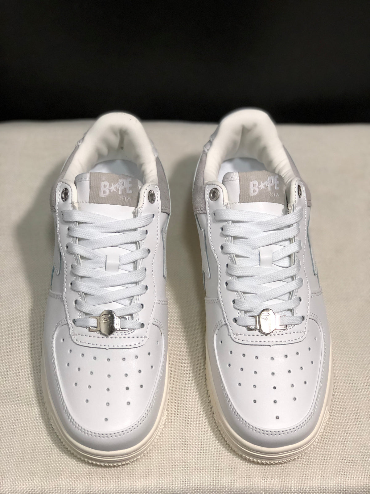 Front view highlighting the perforated white toe boxes, lace closure, and metallic lace accessories.