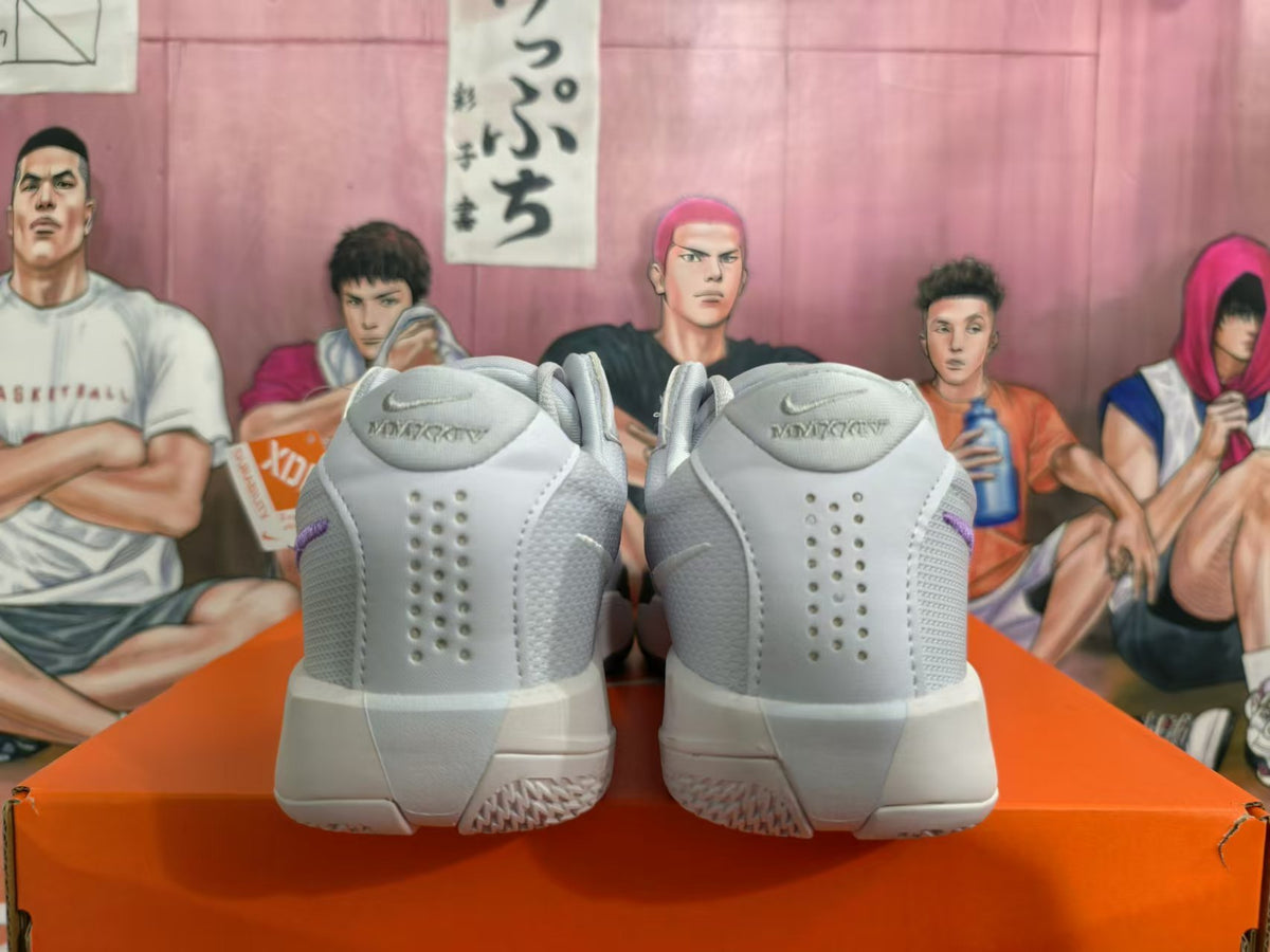 Rear view of gray and white Nike shoes with perforated heel panels and visible Immortality text.