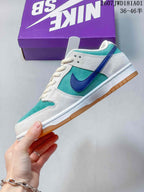 Side view of a teal and white Nike SB Dunk Low Pro sneaker with a blue Swoosh and gum-colored outsole.