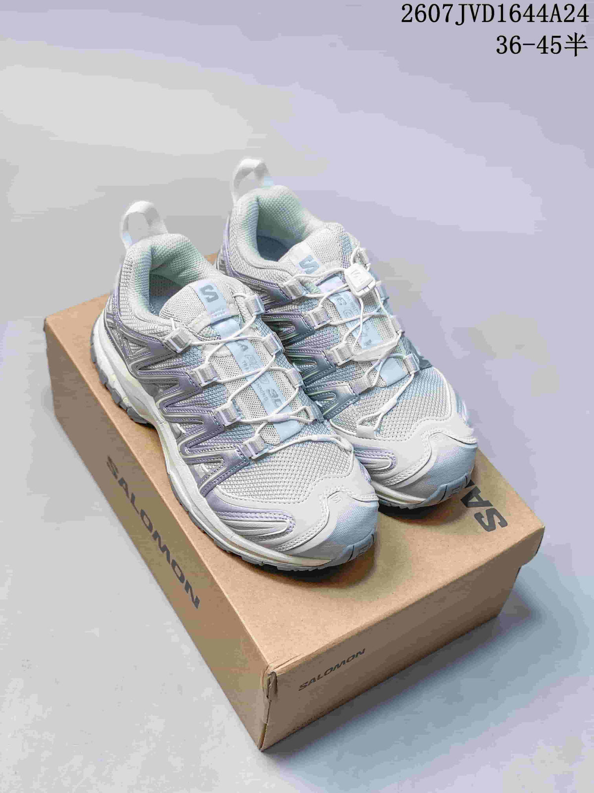 Pair of light gray Salomon XA Pro 3D Seasonal sneakers displayed on a Salomon shoebox, showing the layered upper and cord-style lacing.