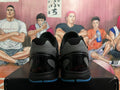 Rear view of black basketball shoes with gray heel panels and blue outsole accents