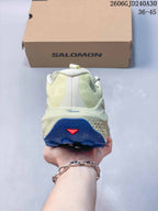 Rear view of a cream Salomon trail shoe showing the heel and blue outsole.