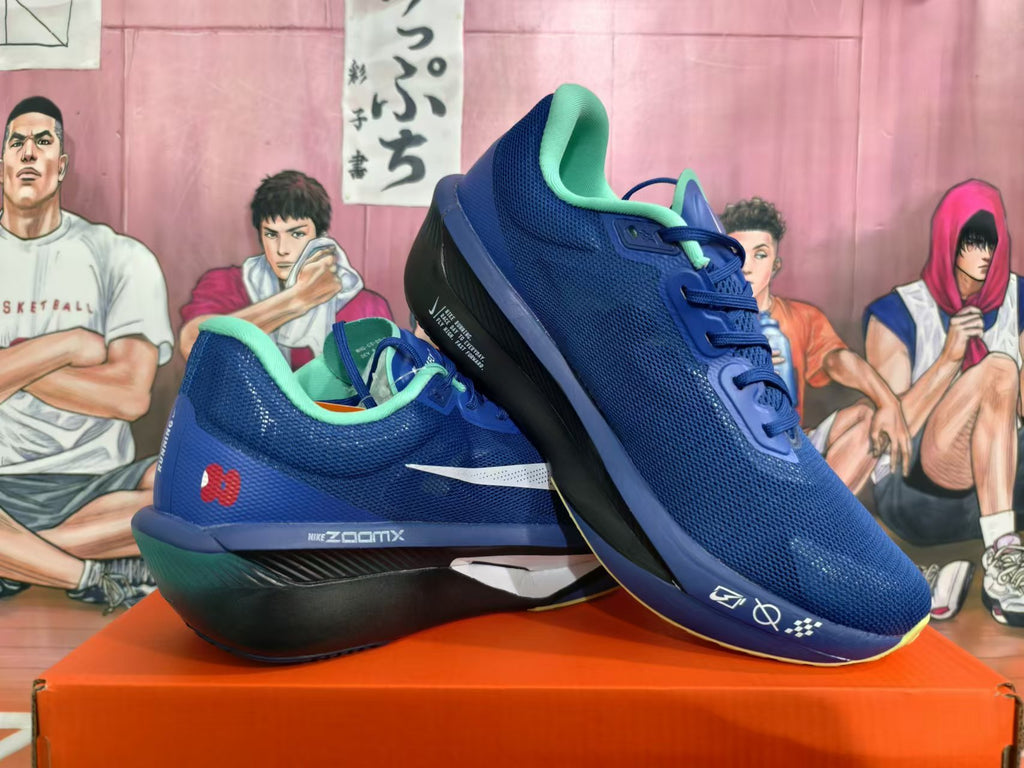 Pair of blue Nike ZoomX running shoes with mint collars and contrasting dark soles.