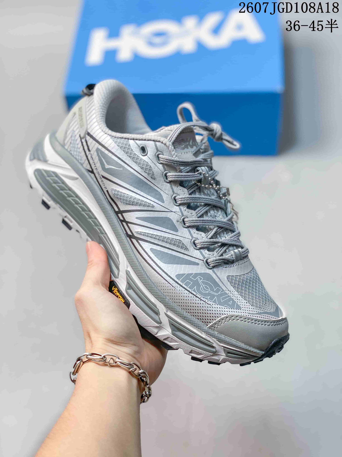 Light gray and white HOKA Mafate Speed 2 sneaker shown at an angled front view.