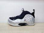 Side view highlighting the metallic-look Swoosh on a silver Nike Foamposite Pro