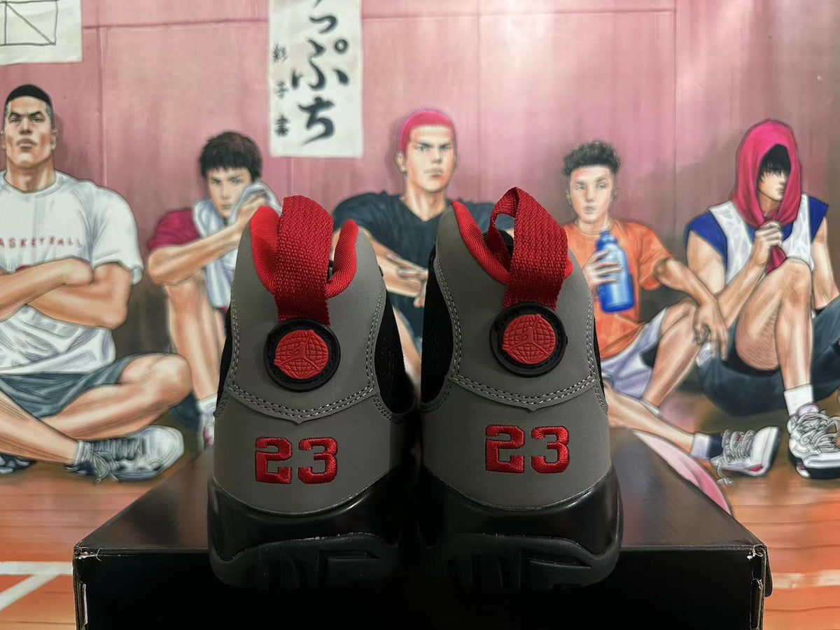 Rear view of black and grey Jordan high-top sneakers with red heel details
