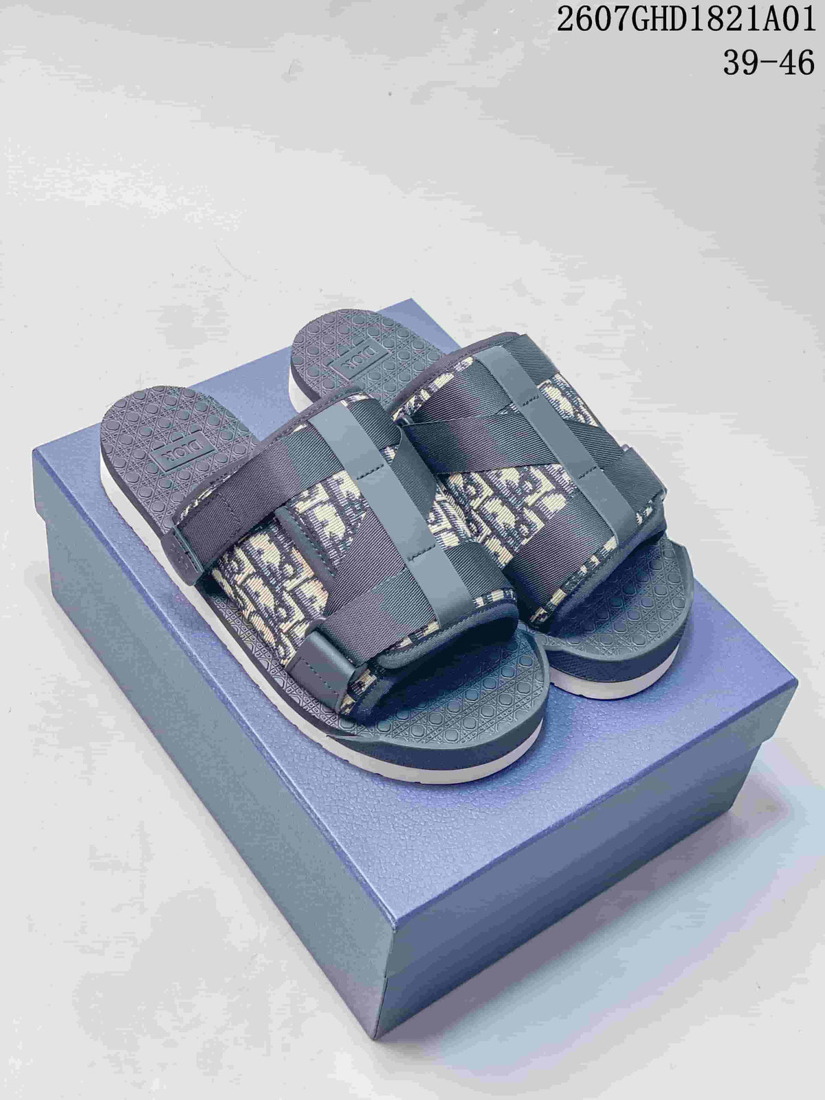Pair of grey Dior Alpha-style Oblique-pattern strap sandals on a box; image shows size range 39–46 and style code 2607GHD1821A01.